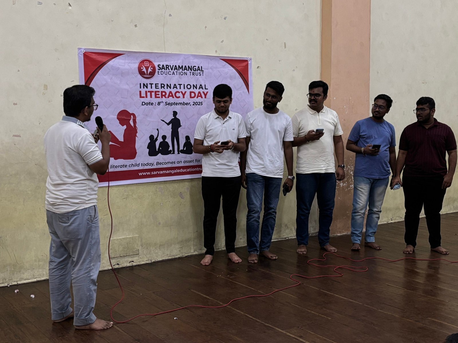 Volunteers educating students on International Literacy Day